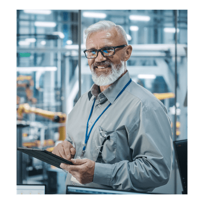 Image of a man standing in front of a production line making electric vehicles